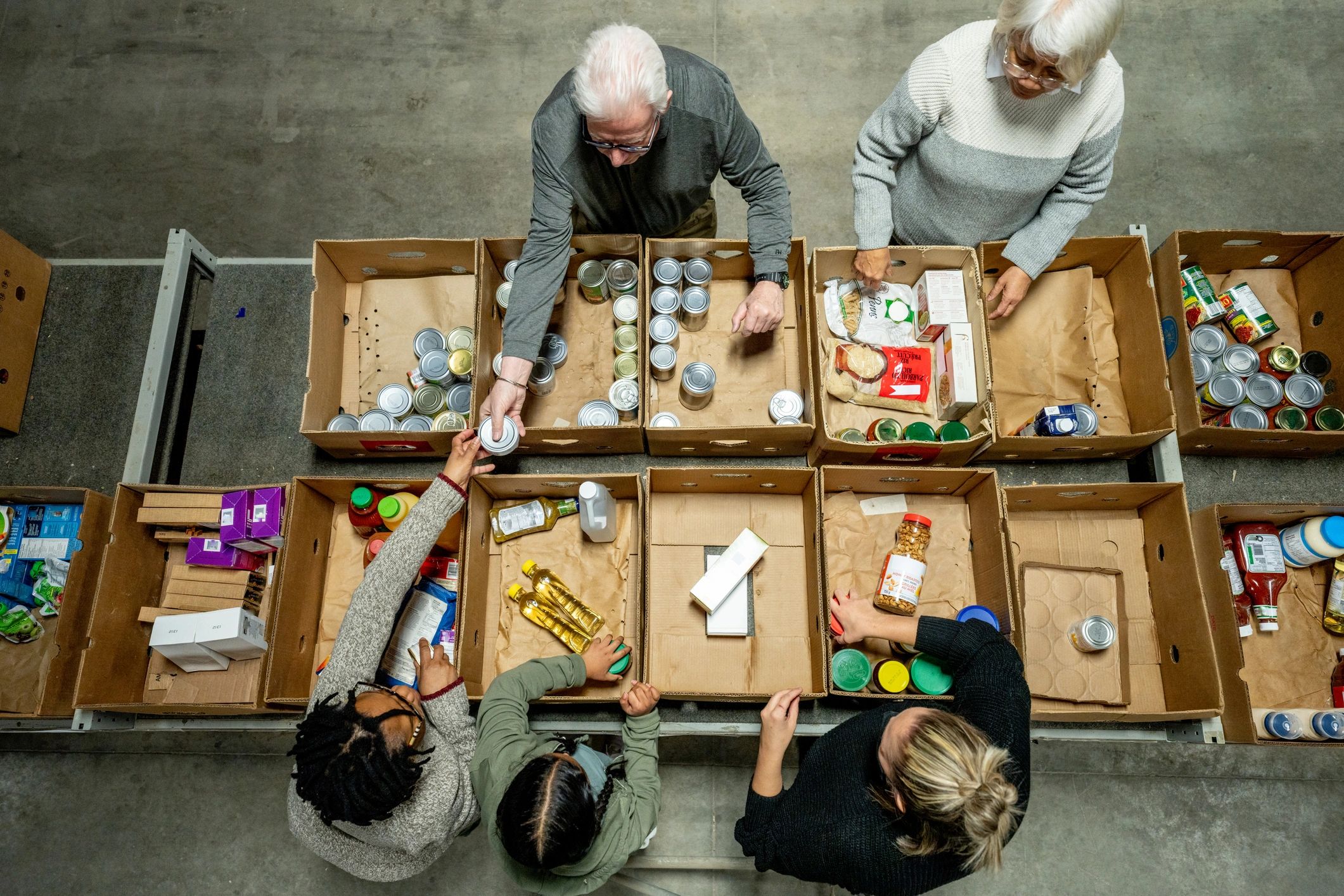 Volunteers packing food boxes at a food bank