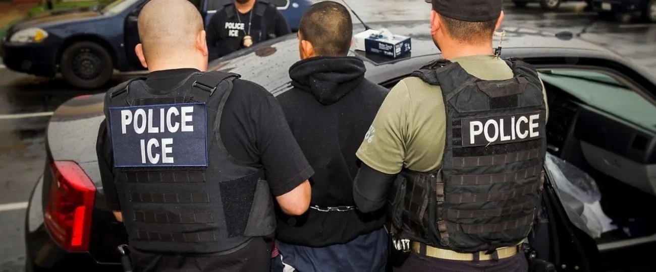 Law enforcement officers wearing ICE vests
