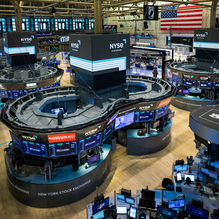NYSE trading floor with screens