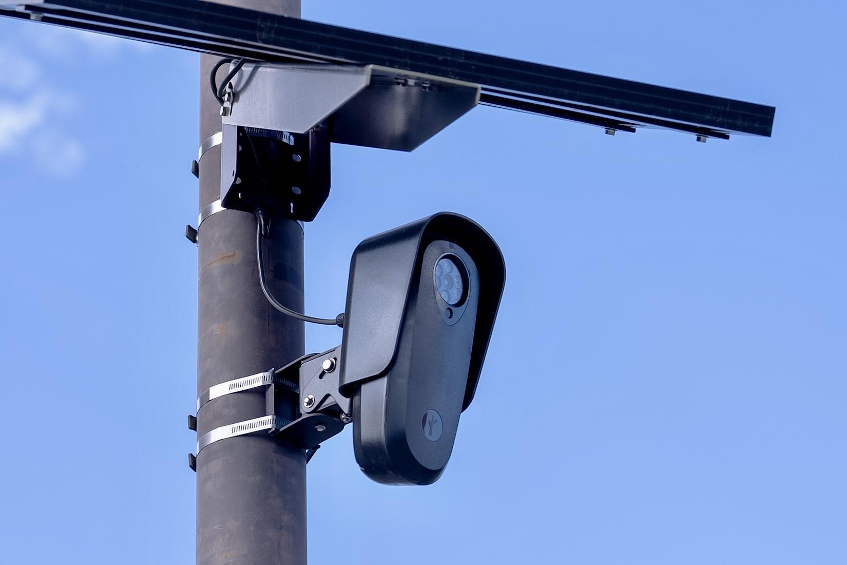 a license-plate-reader camera on a pole