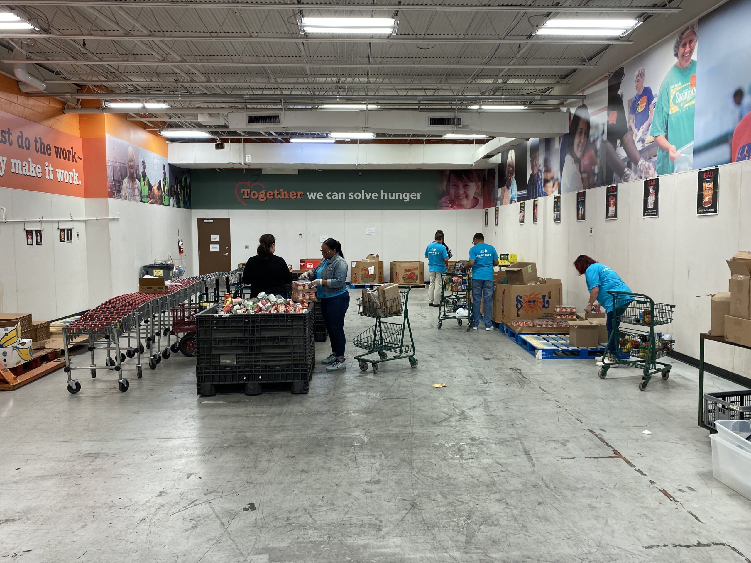 Volunteers packing groceries at a food bank