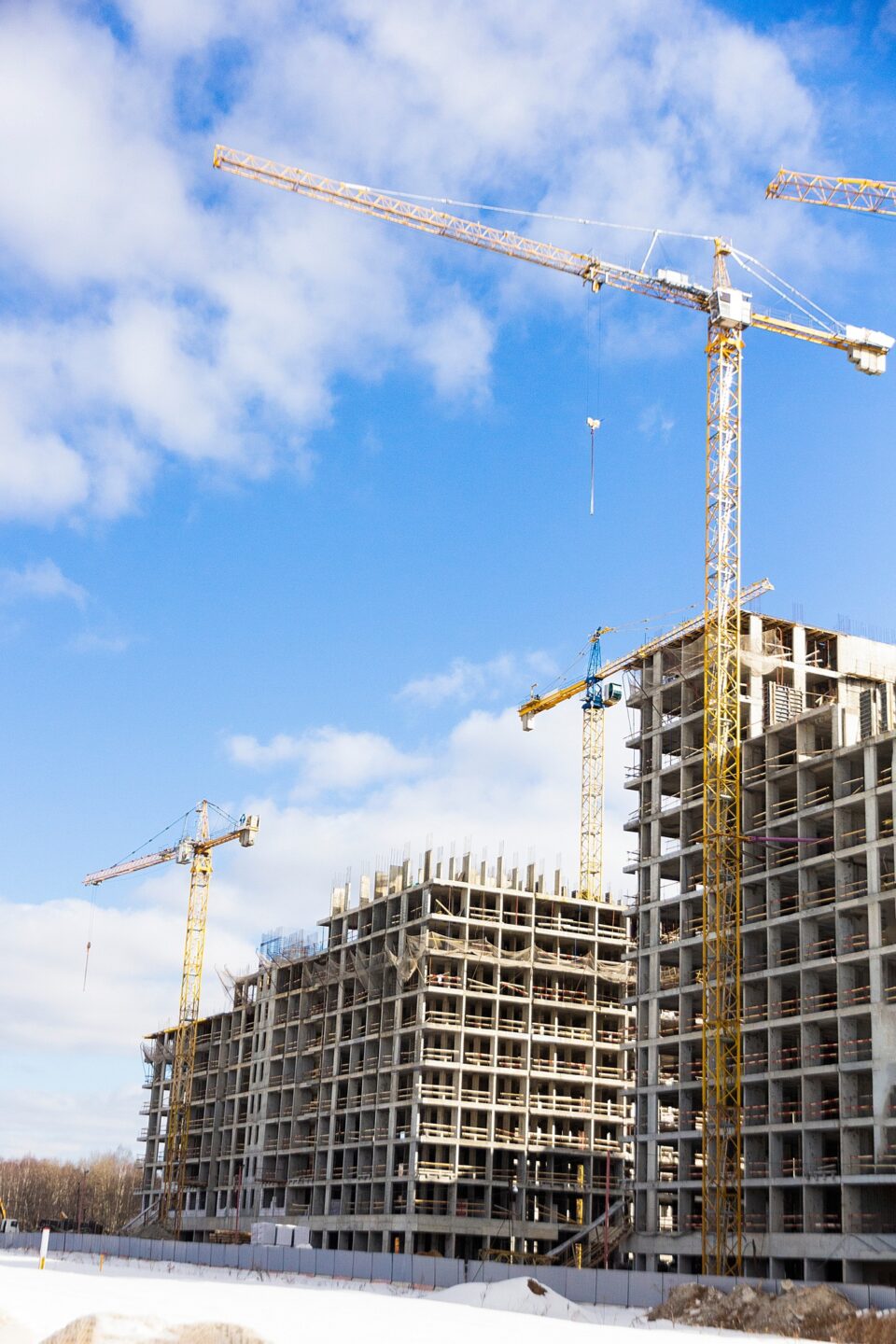 Apartment buildings under construction with tower cranes