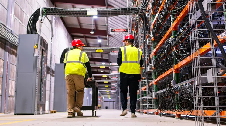 workers inside a data center manufacturing facility