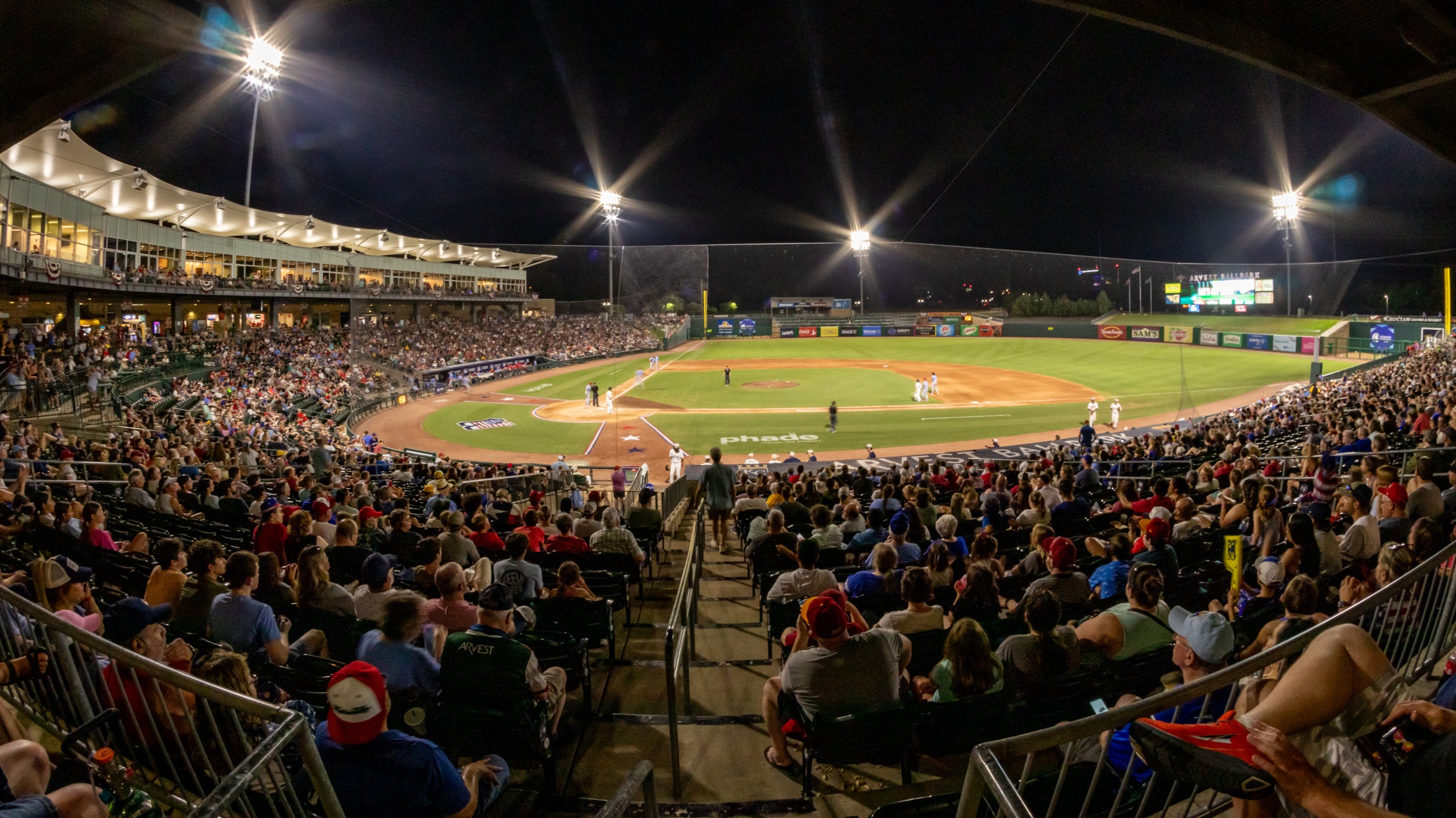 A packed minor league baseball stadium at night