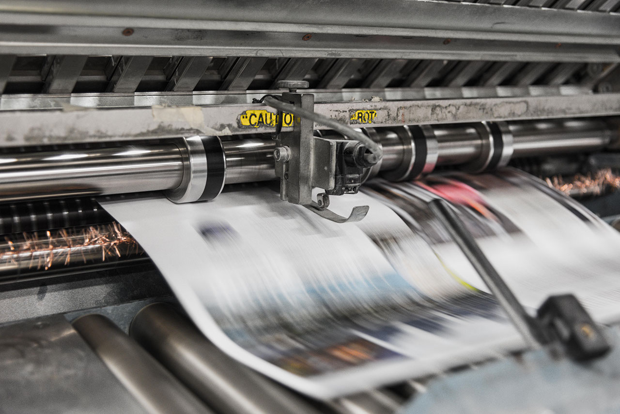 Newspaper web running through a printing press