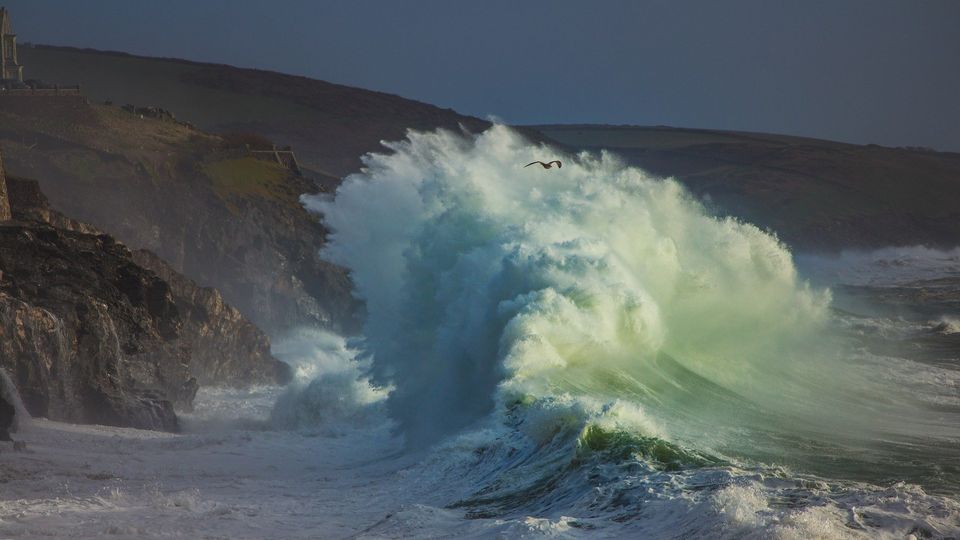 Storm waves crash on a rocky coast