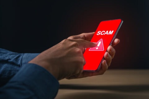 Phone displaying a scam warning