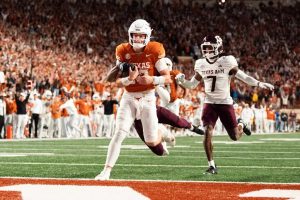 Arch Manning of the Texas Longhorns running with the football