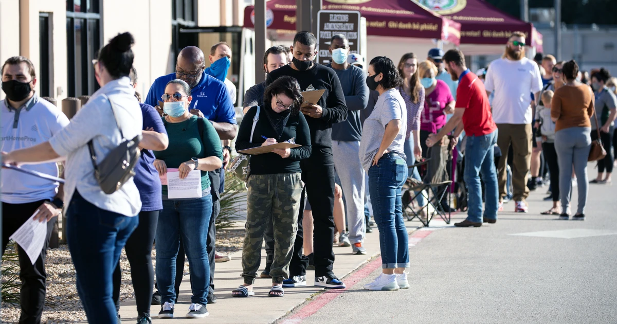 File photo: Voters wait in line at an early voting site in Texas
